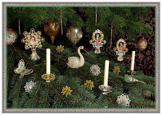 Vintage Christmas tree adorned with ornate glass ornaments, candles, a swan figurine, and delicate lace decorations.