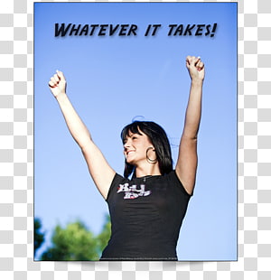 A joyful woman with arms raised triumphantly against a clear blue sky, wearing a black t-shirt with text.