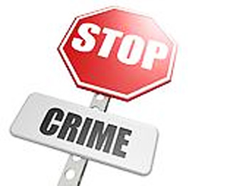 Red octagonal STOP sign mounted above a gray rectangular sign reading "CRIME", symbolizing crime prevention.