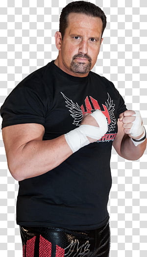 Professional wrestler in black T-shirt with red winged logo, white hand wraps, and black/red pants, posing confidently.