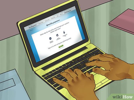 Person typing on a yellow laptop displaying a vacation planning website interface.