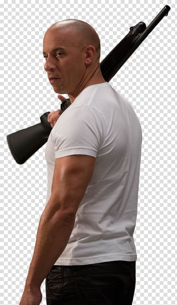 Vin Diesel in a white t-shirt holding a shotgun over his shoulder, looking over his shoulder with intensity.