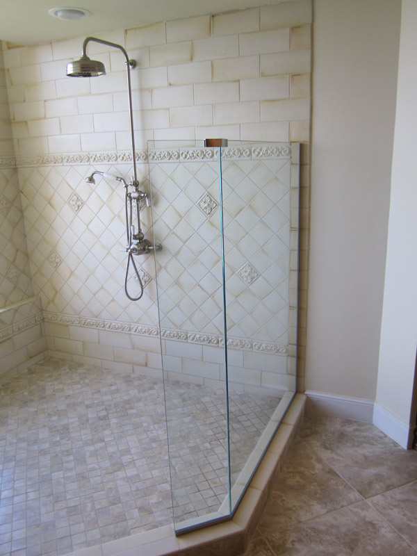 Elegant Walk-In Shower Design with Glass Enclosure and Tile Accents