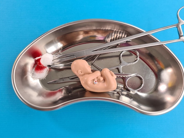 Surgical medical instrument and child abortion closeup | Premium Photo