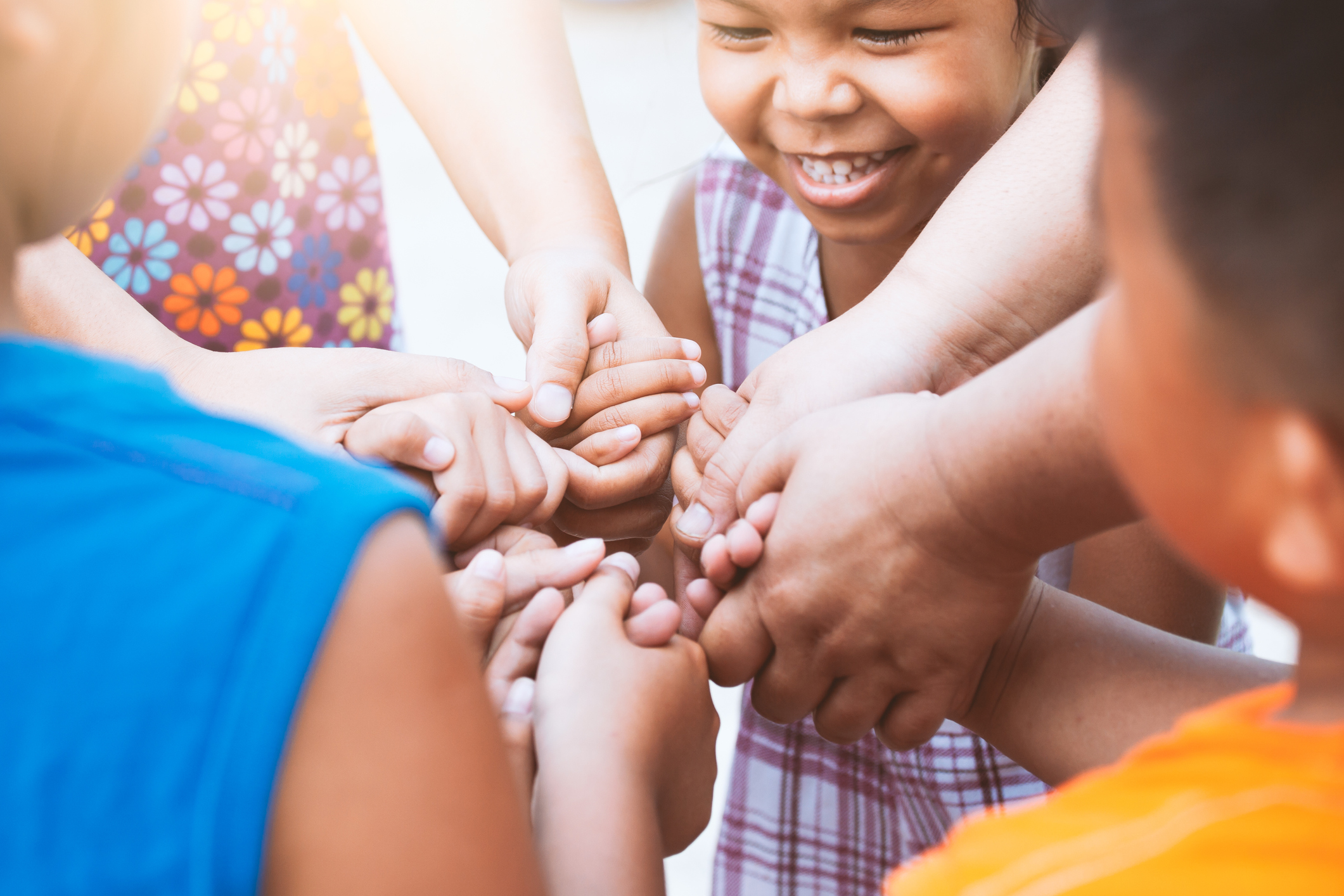 Children and parent holding hands and playing together with unity ...