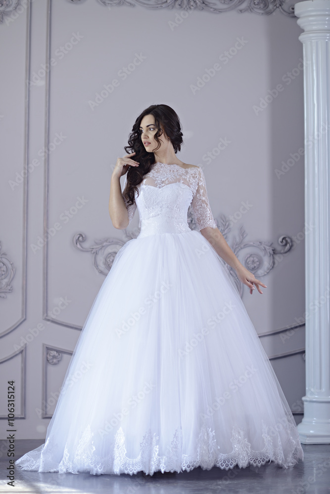 Beauty bride in bridal gown indoors. Beautiful model girl in a ...