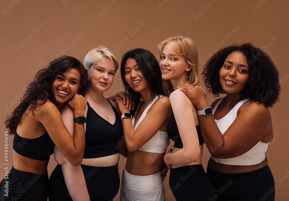 Five women of different body types embracing together. Cheerful ...