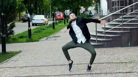 Crazy funny man dancing on the street, very pleased