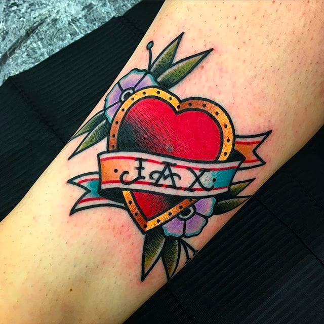 FIne line style heart and banner tattoo located on the