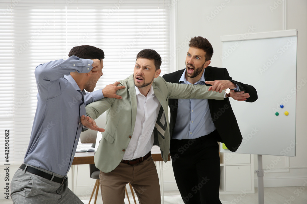 Man interrupting colleagues fight at work in office, New Africa ...