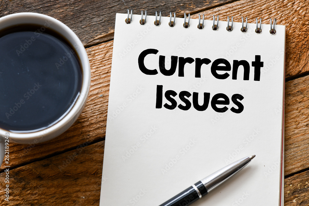 CURRENT ISSUES word on a wooden background. current issues concept ...