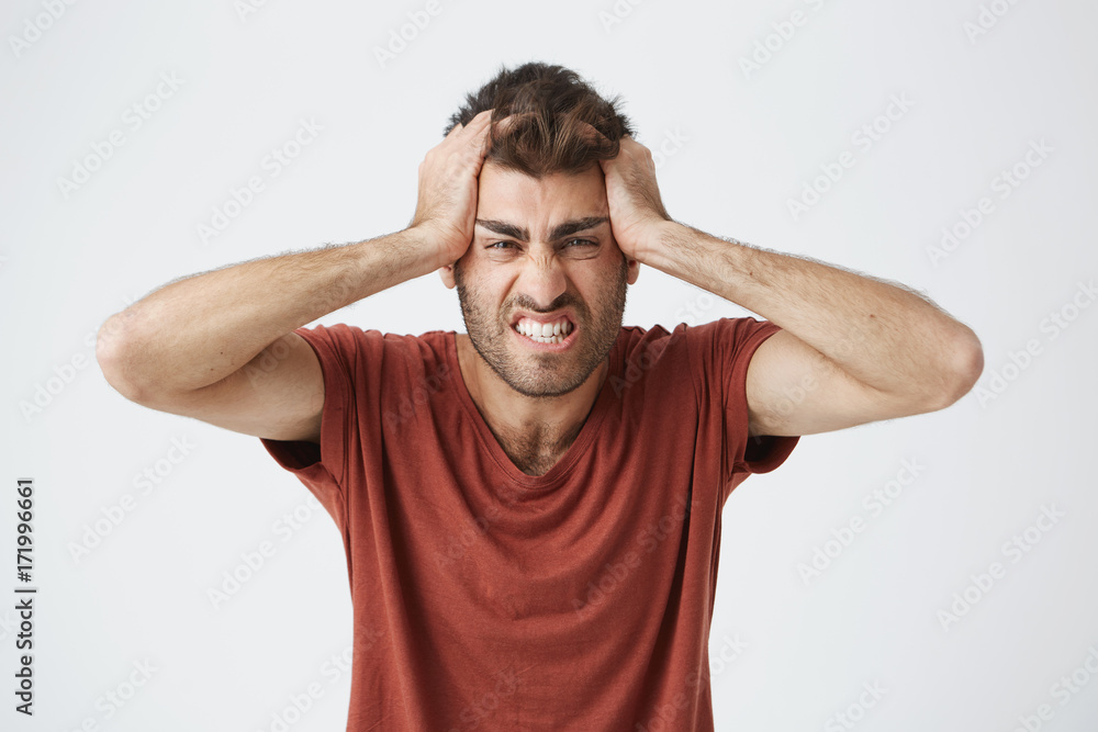 Angry good-looking caucasian male in red t-shirt having mad ...