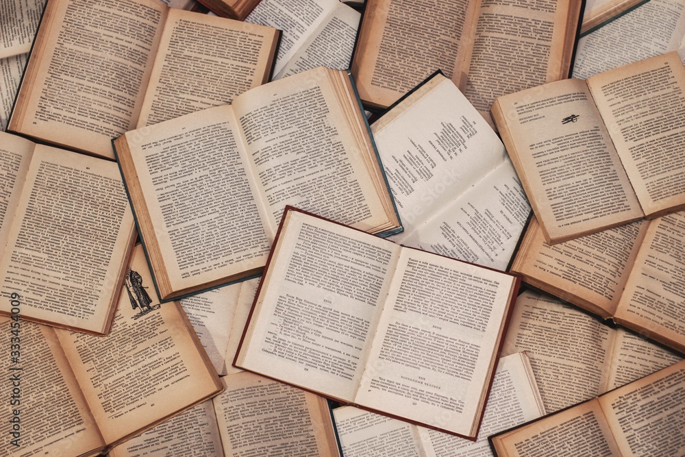 Poster, Wandbilder Overhead closeup shot of open books of literature -  perfect for background, 40x26.7 cm