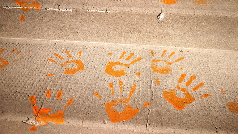 Orange handprints remember childrens unmarked graves ...