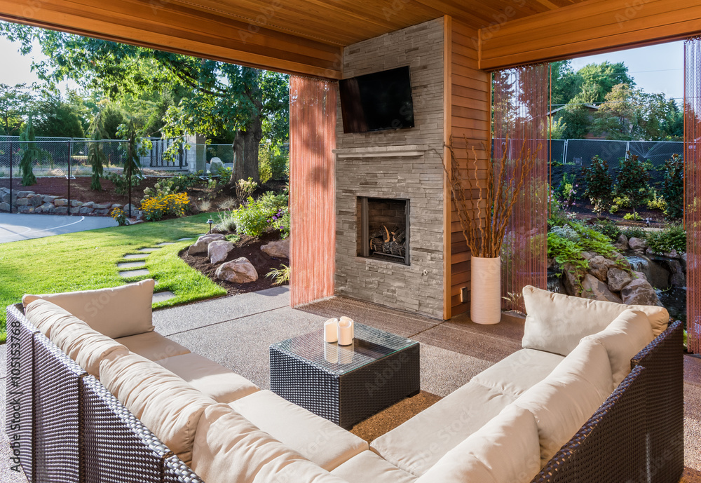 Poster, Wandbilder Beautiful covered patio outside new luxury home with  television, fireplace, and, 40x26.7 cm