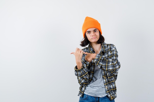 Free Photo | Little woman in t-shirt and jacket pointing thumb ups ...