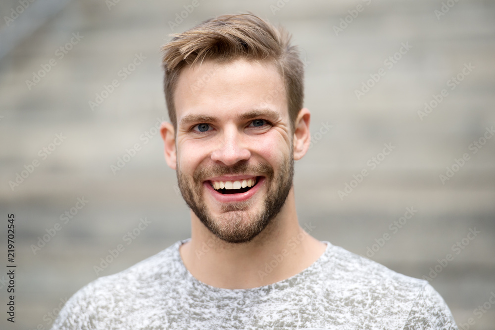 Man with perfect brilliant smile unshaven face defocused ...