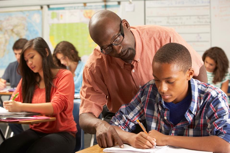 teacher helping student