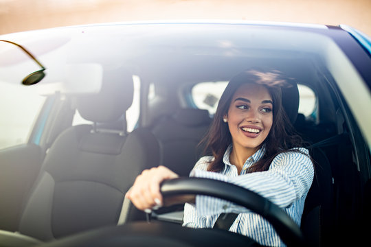 Happy woman driving a car and smiling. Cute young success happy ...