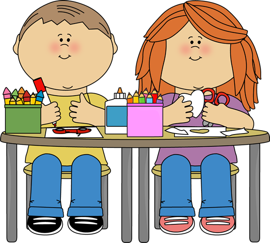 Two children sitting at a table doing arts and crafts with crayons, glue, scissors, and paper.