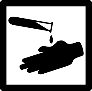 Test tube dripping liquid onto a gloved hand, symbolizing chemical safety or lab hygiene.