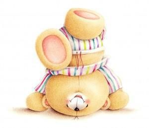 A soft yellow teddy bear lying on its back, wearing a colorful striped scarf and a cozy knitted hat.