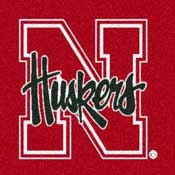 Nebraska Cornhuskers logo featuring a white block 'N' with green script 'Huskers' on red background.