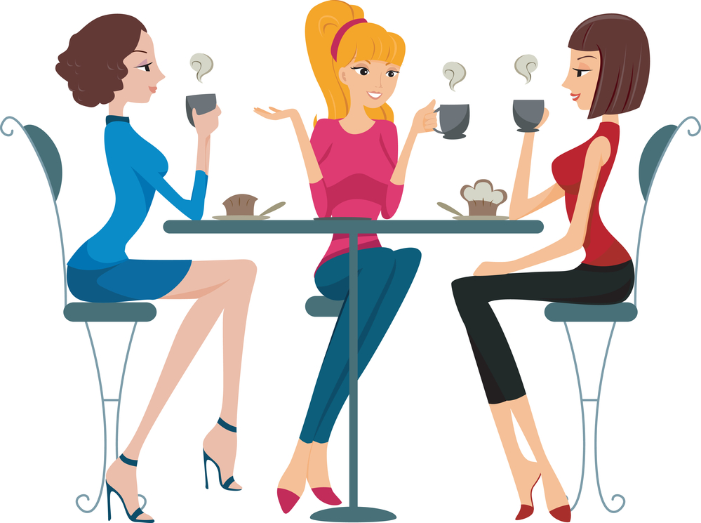 Three women chatting over coffee at a café table, enjoying pastries and warm drinks.