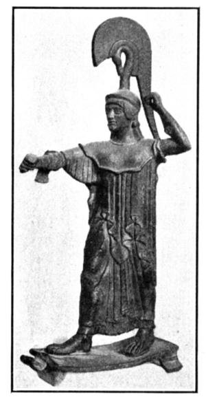Ancient bronze statue of Athena holding a spear and shield, wearing a helmet and chiton, standing on a base.