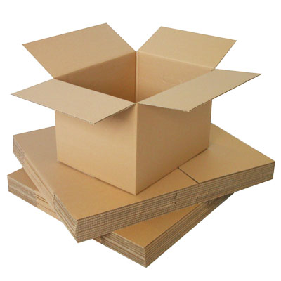 Open cardboard box resting on flat corrugated sheets, ready for packing and shipping.