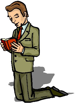 Man in suit kneeling and reading a red book, possibly praying or reflecting.