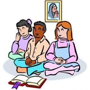 Three diverse children sitting cross-legged, reading a book together with a framed portrait on the wall behind them.