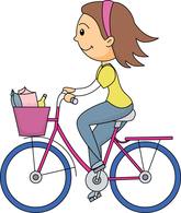 A smiling girl with brown hair and a pink headband rides a pink bicycle with a purple basket full of groceries.