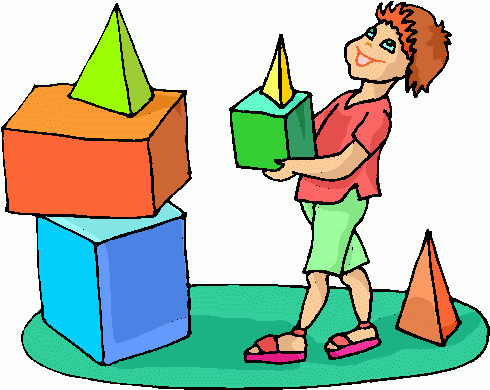A smiling child in a red shirt stacks colorful geometric blocks-cubes and pyramids-on a green mat, learning shapes and spatial reasoning.