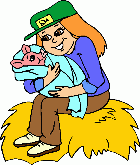 A smiling woman in a green cap holds a pink piglet wrapped in a blue blanket while sitting on a hay bale.