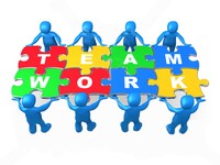 Blue figurines assembling colorful puzzle pieces spelling "TEAMWORK" to symbolize collaboration and unity.