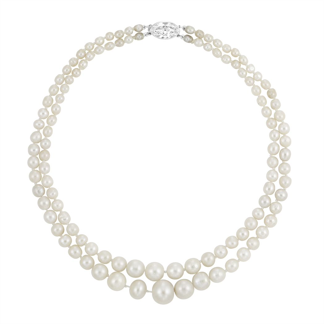 Elegant double-strand pearl necklace with lustrous white pearls and a sparkling oval diamond clasp.