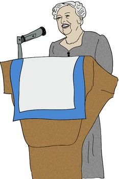 Elderly woman with gray hair speaking at a podium with microphone, smiling warmly.