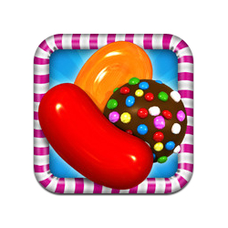 Colorful candy assortment including jelly beans, chocolate ball, and gummy candies in a striped frame.