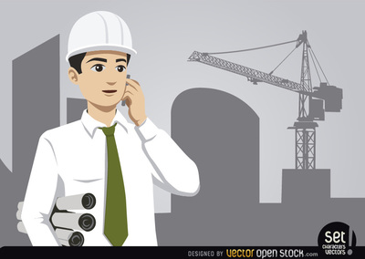 Engineer in white hard hat and shirt holding blueprints, talking on phone with construction crane in background.