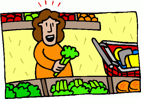 A cheerful woman in an orange shirt holds fresh broccoli while shopping in a grocery produce aisle with a cart nearby.