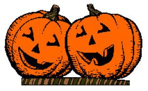 Two orange jack-o'-lanterns with carved smiling faces sitting side by side on a striped surface.