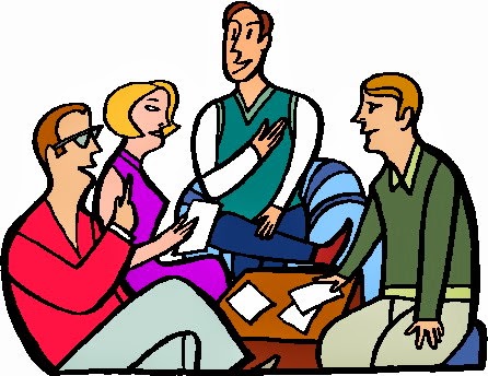 Four diverse people in a collaborative meeting, discussing documents and gesturing actively.