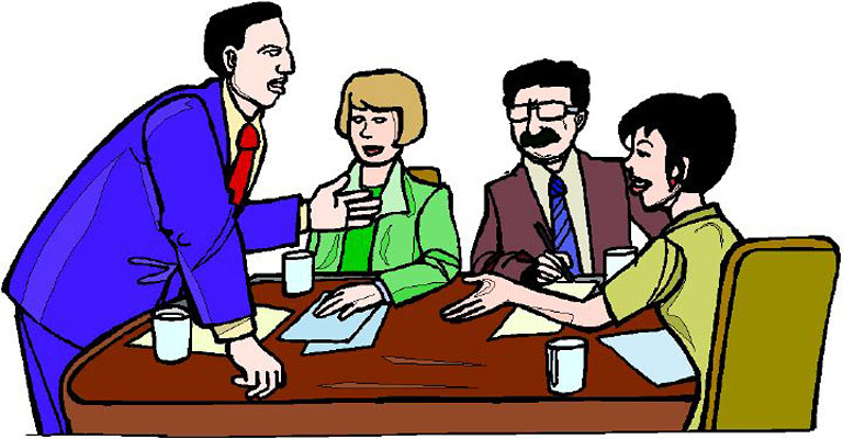 Four business professionals engaged in a collaborative meeting around a conference table with documents and coffee cups.