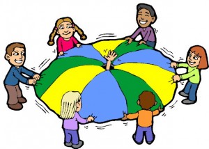 Six diverse children smiling while holding and lifting a colorful parachute in a circle during a group activity.