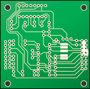Green printed circuit board (PCB) with white conductive traces, pads, and four mounting holes at corners.