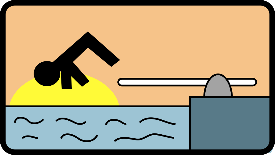 Silhouette of a swimmer diving into water at sunset beside a pool edge with a starting block.