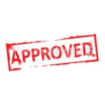 Red "APPROVED" stamp on white background, angled and textured like an official seal.