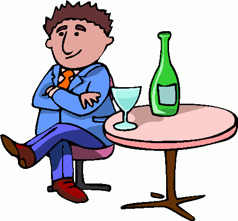 A smiling businessman in a blue suit sits confidently at a small table with a green bottle and glass of wine.