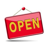 Red glossy "OPEN" sign hanging from a string with a red pin, indicating business is open for customers.